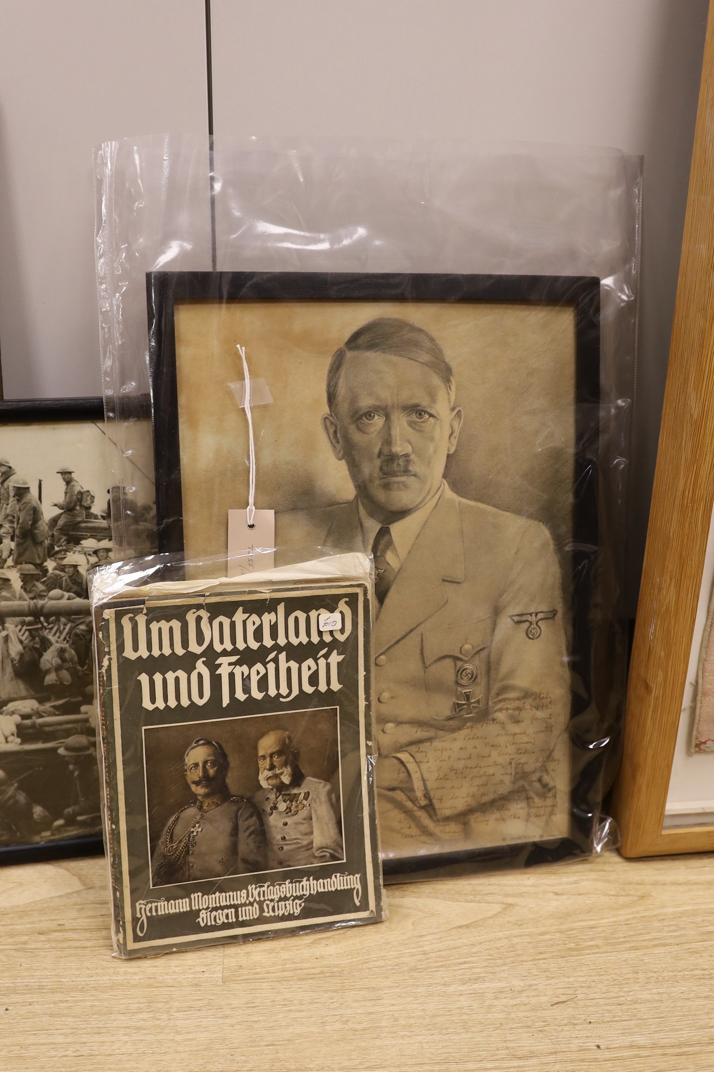 A German monochrome 1914-18 propaganda print, frame 60cm wide, an assortment of World War Two maps and two leather satchels